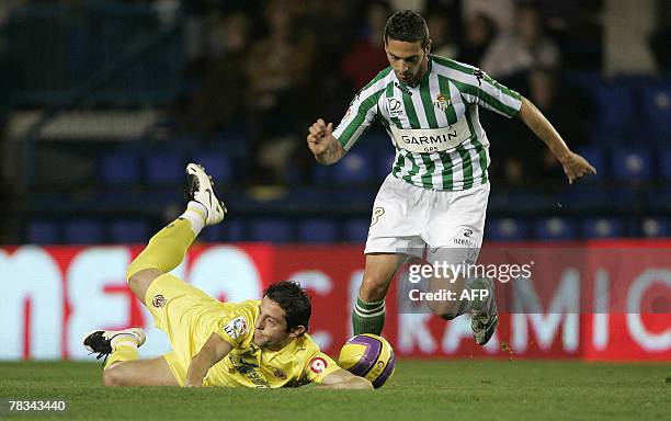 Villarreal's Turkish Kahveci Nihat falls by Betis's Cesar Arzu during their Spanish league football match at the Madrigal Stadium in Valencia, 09...