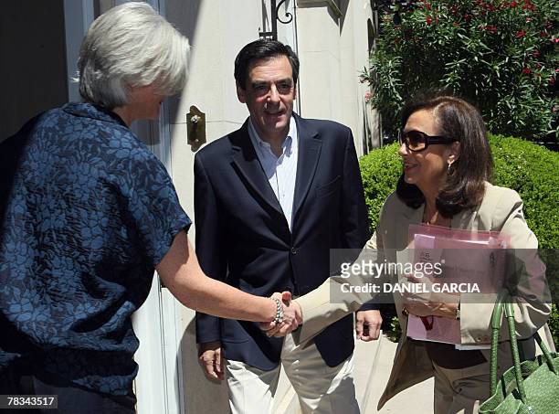 French Prime Minister Fran?ois Fillon's wife Penelope and Yolanda Pulecio mother of Colombian hostage Ingrid Betancourt shake hands next to Francois...