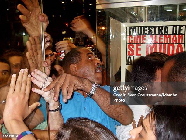 Cubans push through the entrance desperately trying to enter the Acapulco movie theatre for the first screening of the 2006 Oscar award winning...