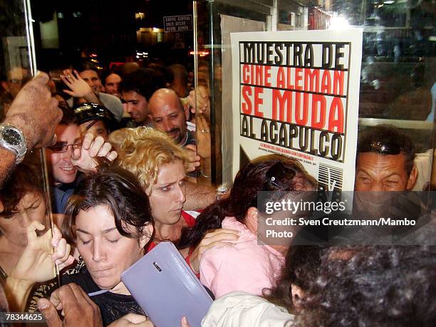 Cubans push through the entrance desperately trying to enter the Acapulco movie theatre for the first screening of the 2006 Oscar award winning...