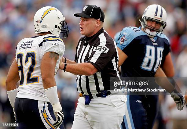 Umpire Bill Schuster separates Marques Harris of the San Diego Chargers from Ben Hartsock of the Tennessee Titans at LP Field December 9, 2007 in...