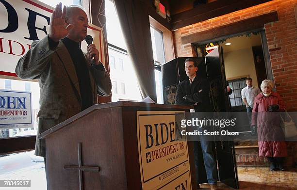 Democratic Presidential hopeful Sen. Joe Biden fields questions as his son Hunter Biden looks on at a campaign stop at 180 Main Pub and Restaurant...