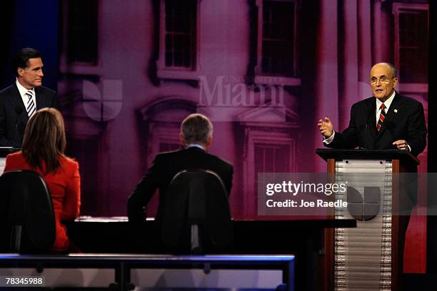 The Republican presidential candidates, former Massachusetts Gov. Mitt Romney and former New York City Mayor Rudy Giuliani stand on stage during the...