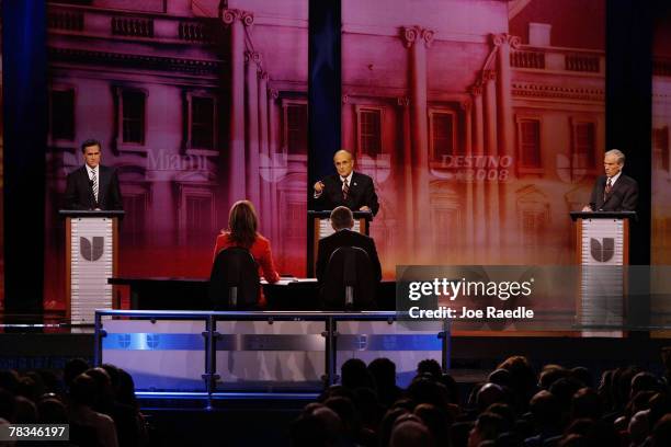 The Republican presidential candidates, former Massachusetts Gov. Mitt Romney, former New York City Mayor Rudy Giuliani and Rep. Ron Paul stand on...