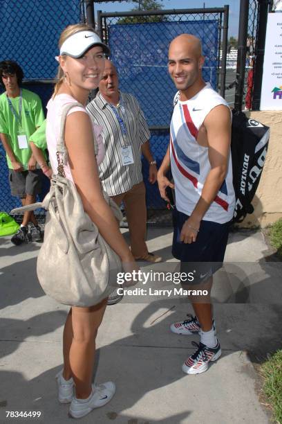 Maria Sharapova and her mixed doubles partner James Blake pose before there match at the Andy Roddick Foundation Celebrity Tennis Exhibition on...