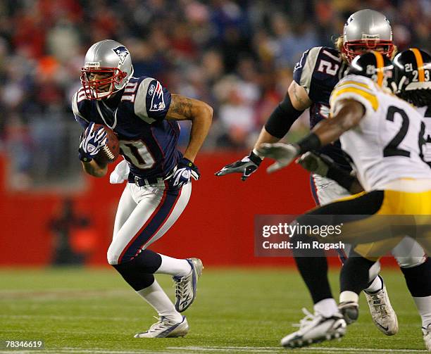 Jabar Gaffney of the New England Patriots gains yardage against the pressure of Deshea Townsend of the Pittsburgh Steelers at Gillette Stadium...