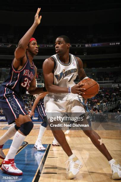 Antawn Jamison of the Washington Wizards dribbles against Jason Collins of the New Jersey Nets at the Verizon Center on December 9, 2007 in...
