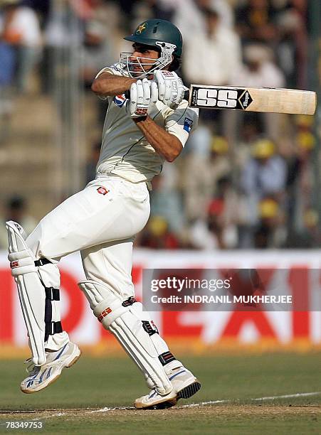 Pakistani cricketer Misbah-ul-Haq plays a shot on the third day of the third Test match between India and Pakistan at the Chinnaswamy stadium in...