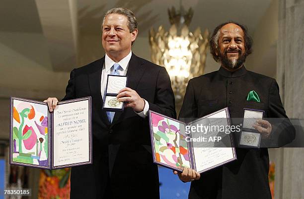 The Nobel Peace Prize laureates, Rajendra Pachauri and Al Gore pose on the podium with their diplomas and gold medals during the Nobel ceremony at...