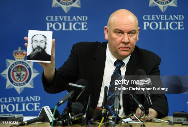 Detective Superintendent Tony Hutchinson of Cleveland Police holds the fake passport picture of John Darwin, the canoeist who turned up after being...