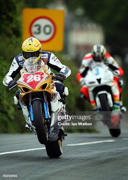 Les Shand and John McGinness in action as he exit's Kirk Michael during Practice of the Isle of Man TT Races on Jun 1, 2007 in the Isle of Man.