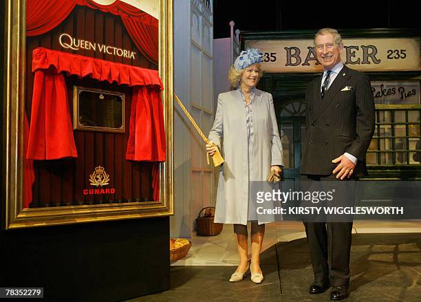 Britain's Camilla, the Duchess of Cornwall and Prince Charles unveil a plaque on stage during a visit to the Cunard liner 'Queen Victoria,' in...