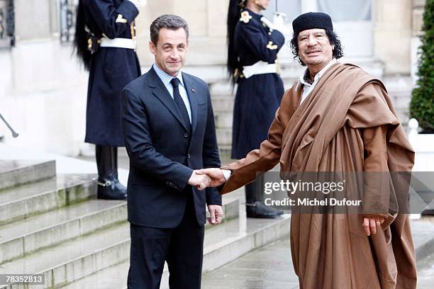 French President Nicolas Sarkozy welcomes Colonel Gaddafi at Le palais de l'Elysee on December 10, 2007 in Paris, France. The Libyan leader Muammar...