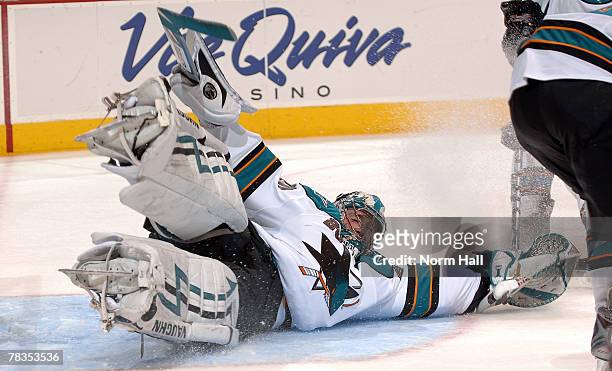 Goaltender Evgeni Nabokov of the San Jose Sharks makes a pad save against the Phoenix Coyotes on December 7, 2007 at Jobing.com Arena in Glendale,...