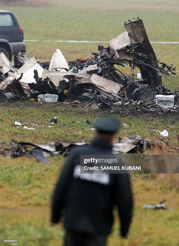 A policeman walks near the wreckage of t