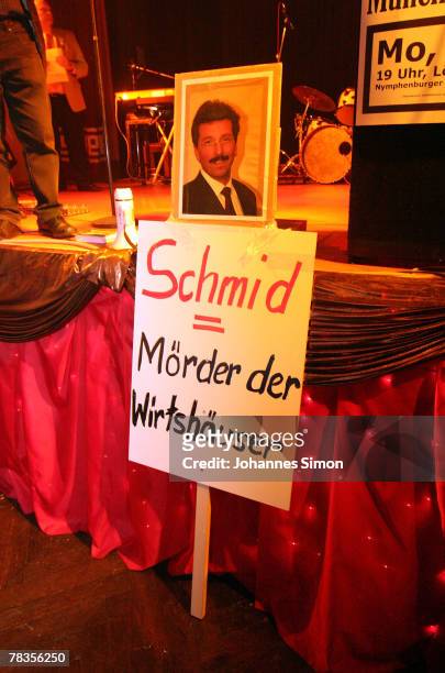 Placard reading "Schmid = murderer of the taverns" and a portrait of Bavarian State Secretary Georg Schmid is seen during a smokers protest rally at...