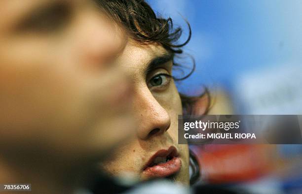 Besiktas's Argentine Matias Delgado watches his coach Ertugrul Saglam speaking during a press conference before the team training session at the...