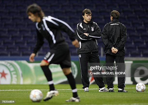 Besiktas's coach Ertugrul Saglam talks with an assistant during their team training session at the Dragao stadium in Porto, 10 December 2007, ahead...