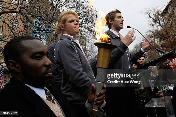 Olympic gold medalists, Joey Cheek speaks as Nikki Stone listens during a rally to protest against the genocide in Darfur outside the Chinese Embassy...