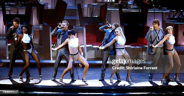 Gary Barlow, Mark Owen, Jason Orange and Howard Donald of Take That perform at Manchester Arena on December 10, 2007 in Manchester, England.