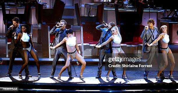 Gary Barlow, Mark Owen, Jason Orange and Howard Donald of Take That perform at Manchester Arena on December 10, 2007 in Manchester, England.