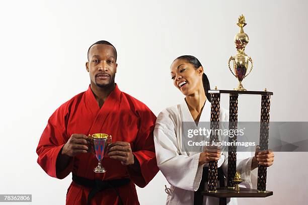 smiling woman holding trophy - segundo lugar fotografías e imágenes de stock