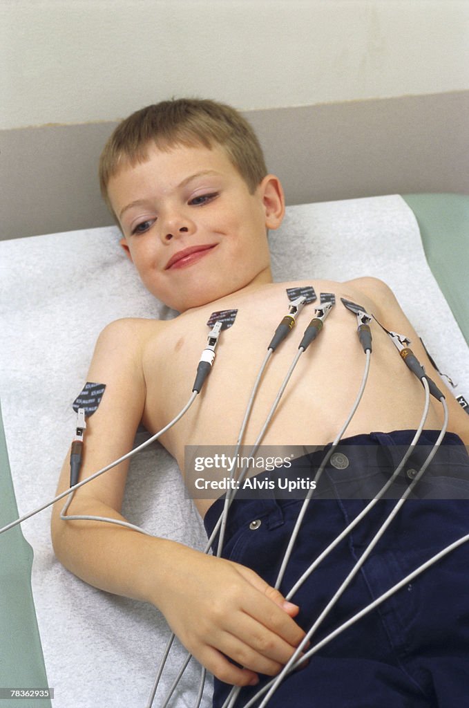 Boy with electrodes checking heart