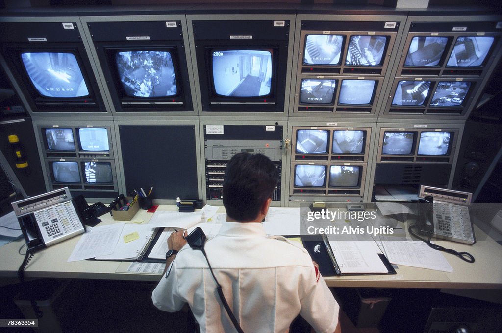 Security officer watching television monitors