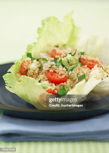 tabbouleh in lettuce leaf - iceberg lettuce stock pictures, royalty-free photos & images