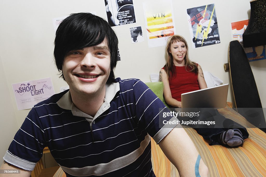 Smiling man sitting on edge of bed