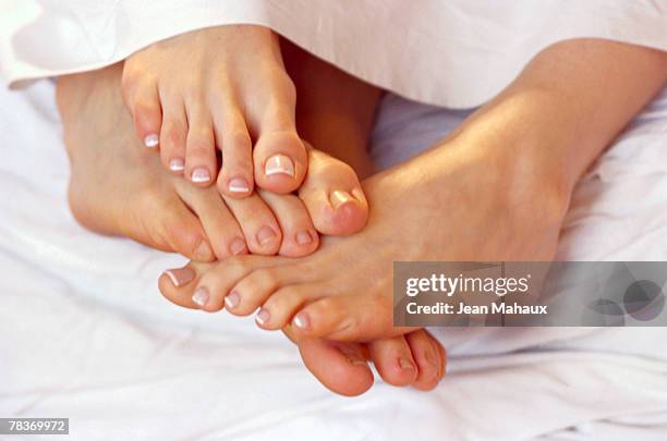 couple playing footsie - playing footsie stock pictures, royalty-free photos & images