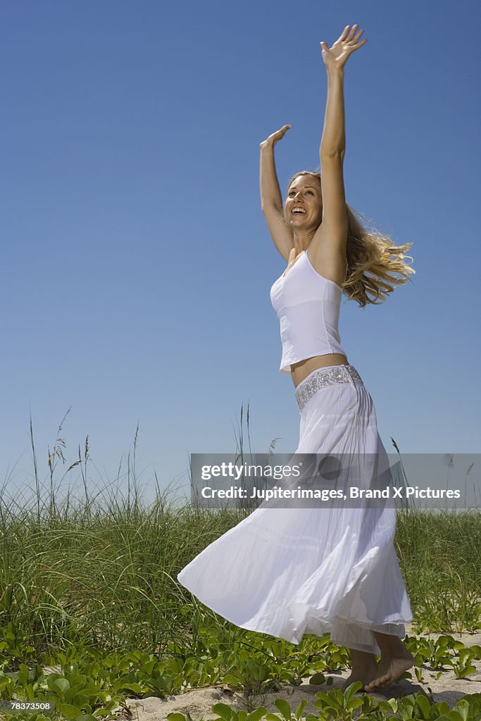 Young woman with arms raised