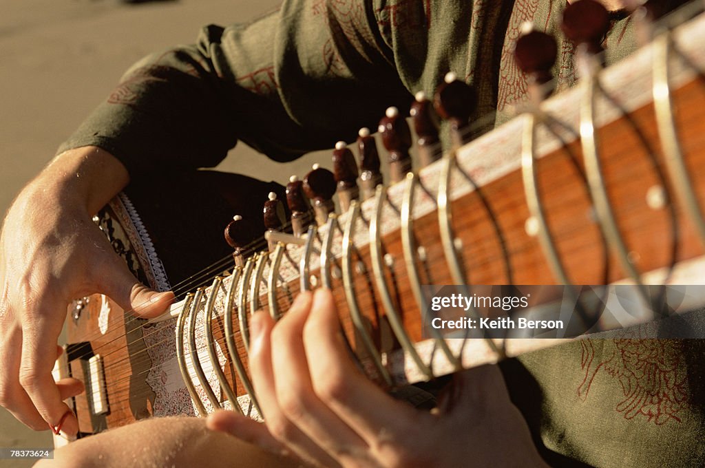 Close-up of man playing sitar