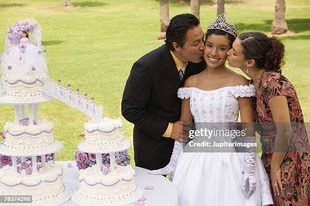 parents kissing daughter at quinceanera - 15th birthday stock pictures, royalty-free photos & images