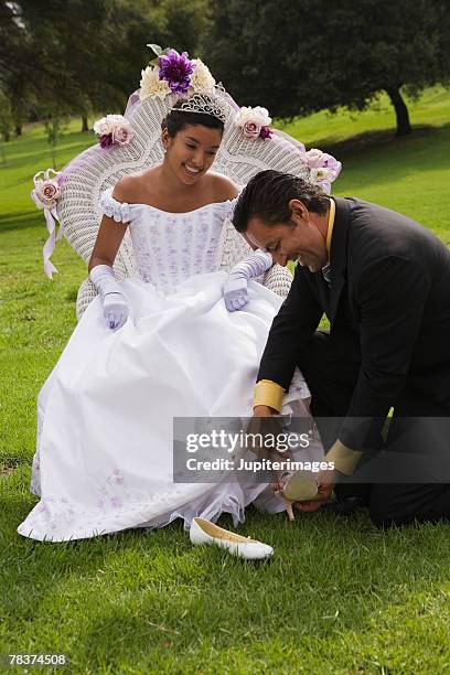 father putting on teenage girls shoes at quinceanera - 15th birthday stock pictures, royalty-free photos & images