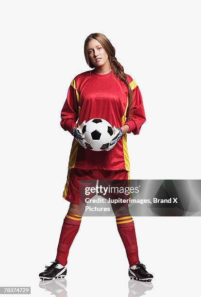 young adult woman holding soccer ball - woman goalie stock pictures, royalty-free photos & images