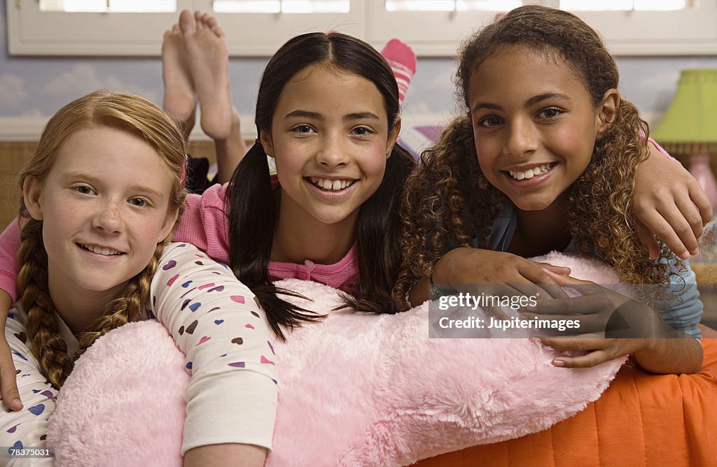 Three smiling preteen girls