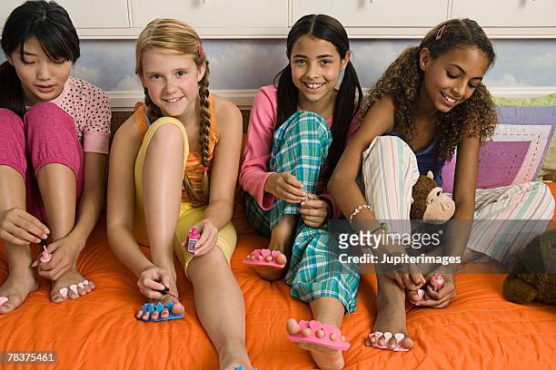 girls painting toenails - black painted toes stock-fotos und bilder