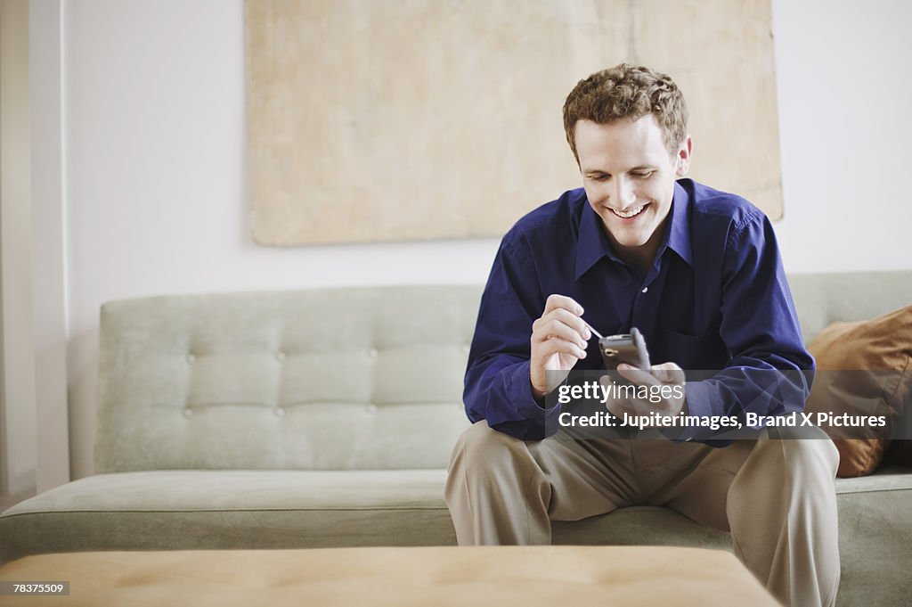 Mid-adult man using PDA