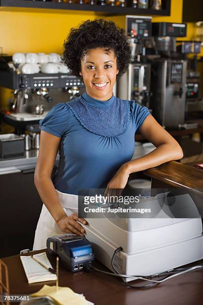 woman standing beside cash register - black woman on cash register stock-fotos und bilder