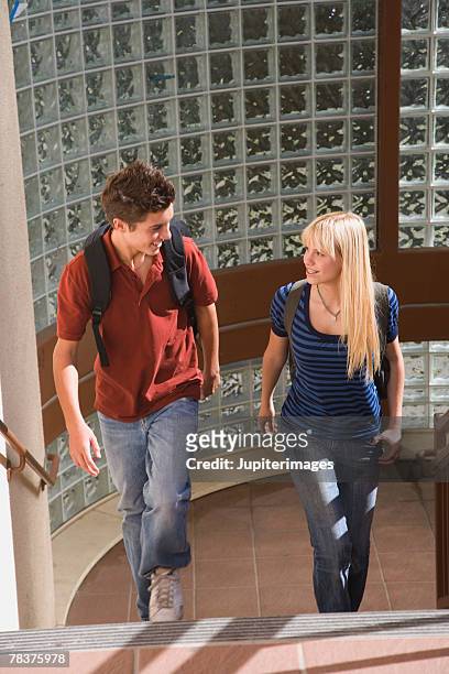 teenage couple walking up stairs - 14 year old blonde girl stock pictures, royalty-free photos & images