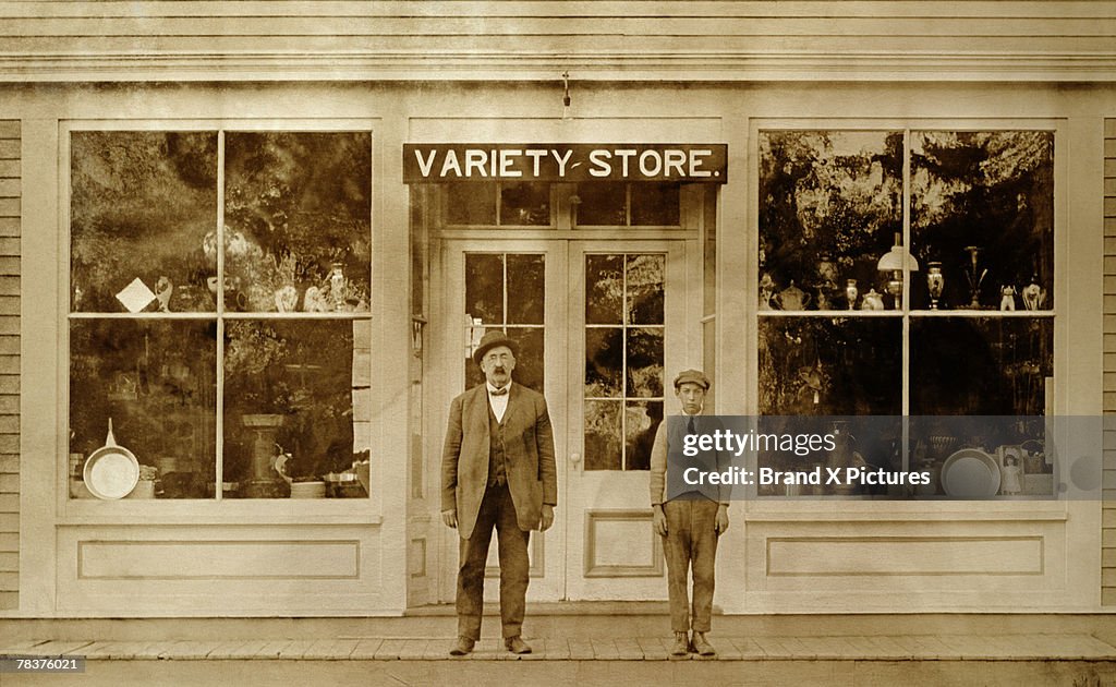 Man and boy standing in front of variety store