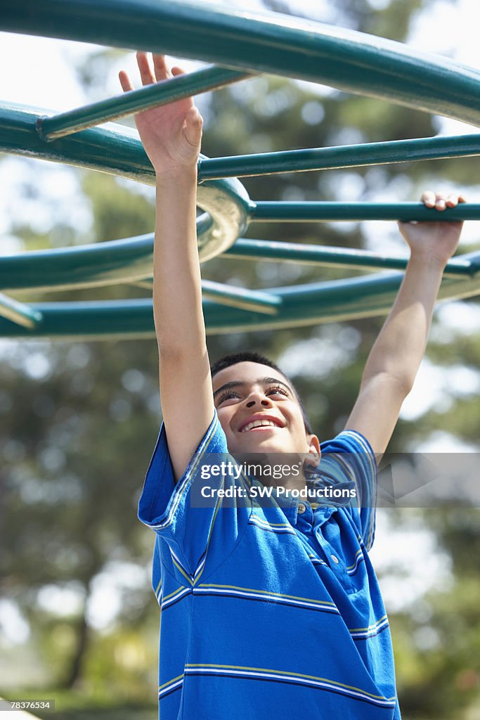 Boy playing on monkey bars