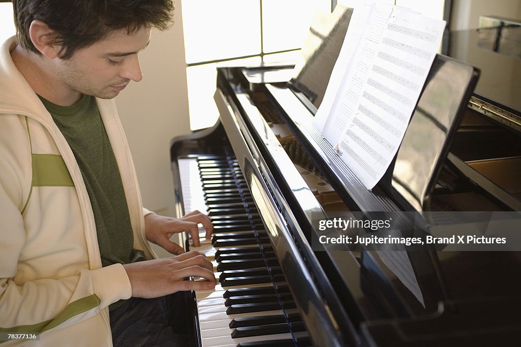 Mid-adult man playing piano