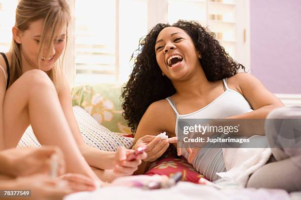 teenage girls having fun at slumber party - nail varnish stockfoto's en -beelden