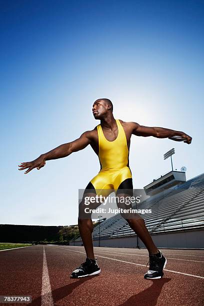 athletic man preparing to throw discus - discus stock-fotos und bilder