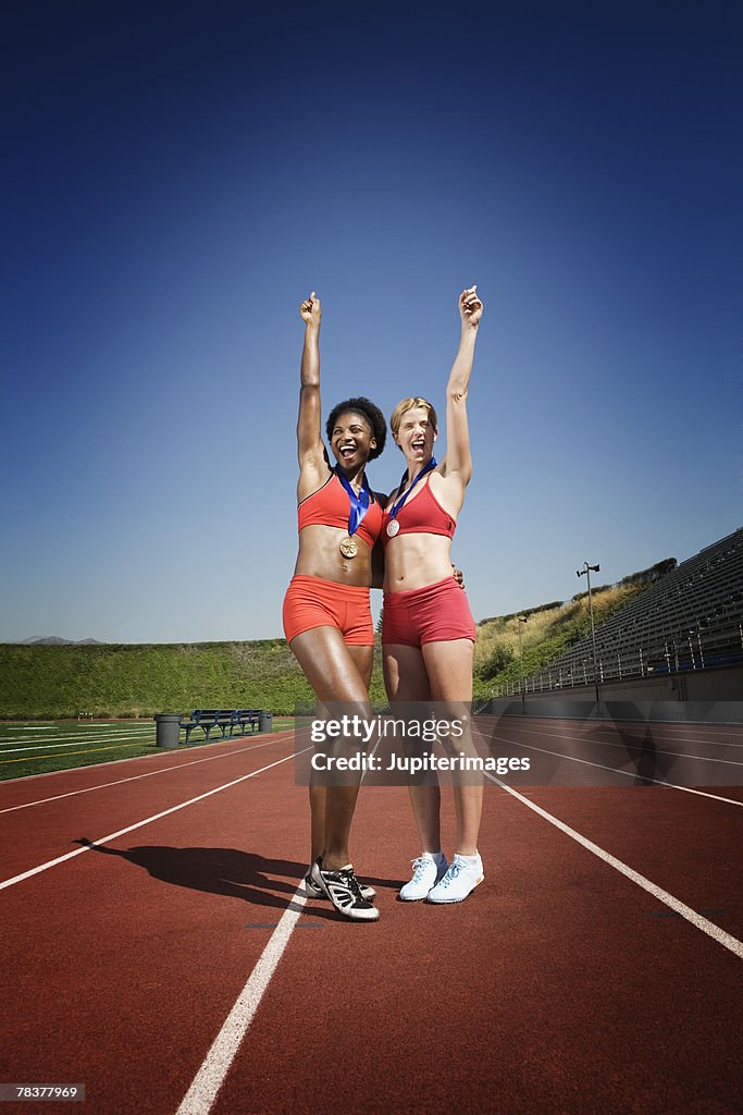 Athletic women showing off medals