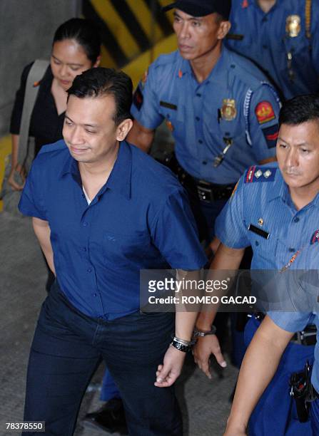Senator Antonio Trillanes leaves the court handcuffed to a police after a court hearing in Manila, 11 December 2007 on the failed 2003 mutiny. The...