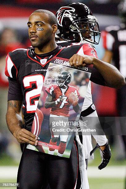 DeAngelo Hall of the Atlanta Falcons holds up a poster of Michael Vick during player intros against the New Orleans Saints on December 10, 2007 at...