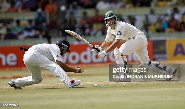 Pakistani cricketer Misbah-ul-Haq looks on as Indian fielder Gautam Gambhir spills a catch during the fourth day of the third Test match between...